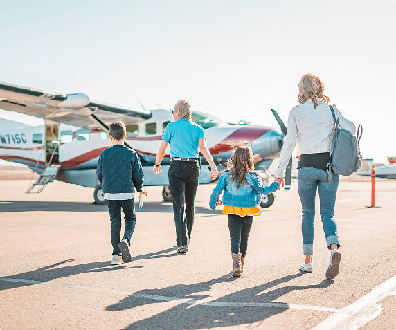 Family boarding a private jet for vacation getaway with airacer