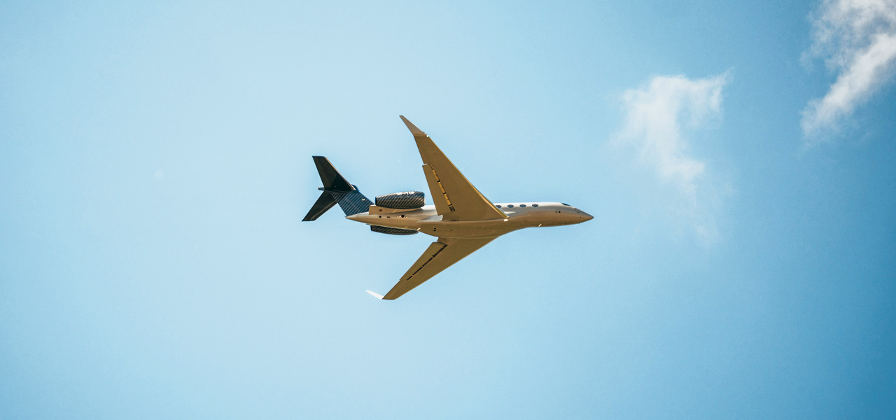 private jet charter flying against clouds