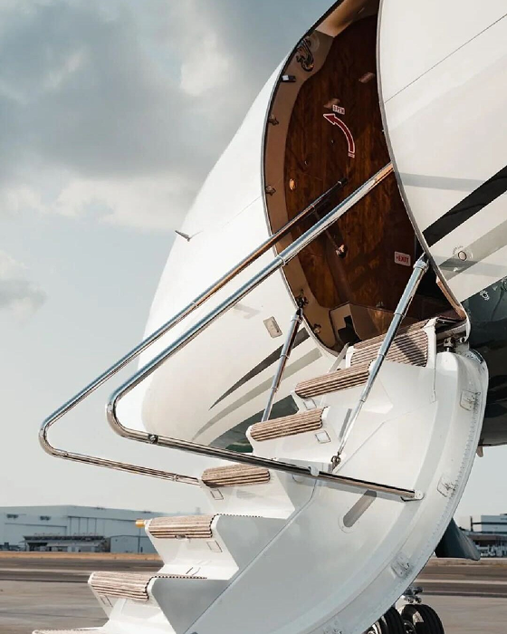 Modern private jet with boarding stairs deployed