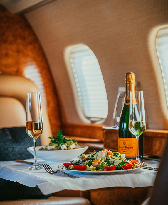 Champagne and gourmet catering aboard luxury jet