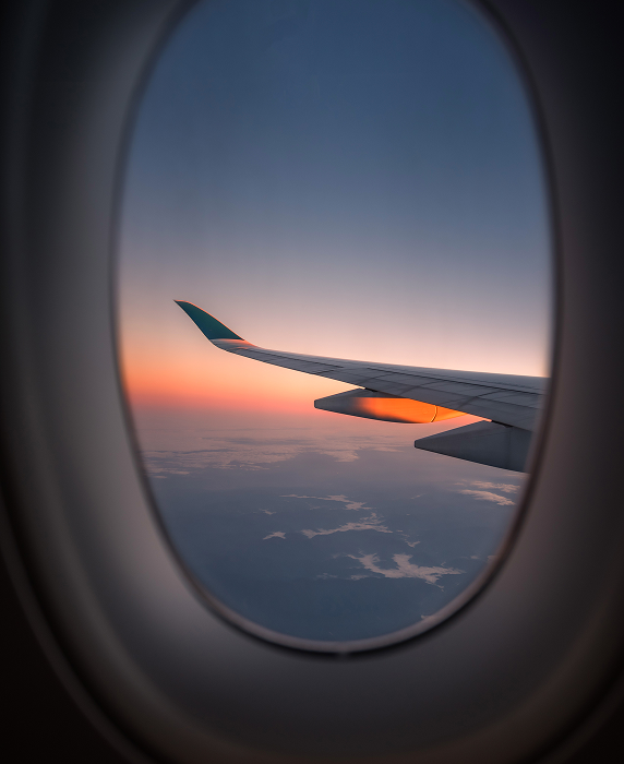 view of the wing on a private jet at sunset